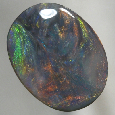 SOLID BLACK OPAL Large opal with moving orange, green and blue SEE VIDEO